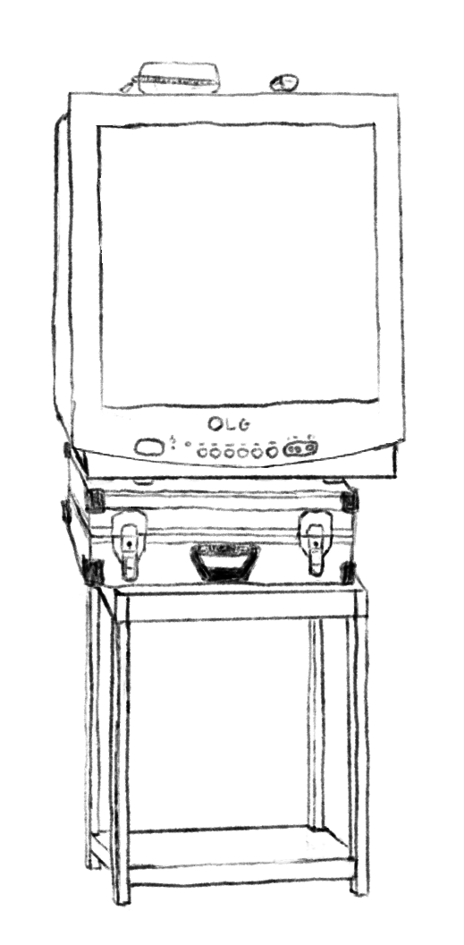 An early 2000s Tv ontop of a small suitcase and table
